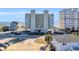 Exterior shot of a multi-story condominium building near the beach, with parking and landscaping at 5806 N Ocean Blvd. # 203, North Myrtle Beach, SC 29582