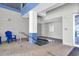 Indoor hot tub with tiled surround, featuring a blue chair and safety railing for easy access at 5806 N Ocean Blvd. # 203, North Myrtle Beach, SC 29582