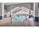 Bright indoor pool area with a vaulted glass ceiling and comfortable lounge chairs nearby at 5806 N Ocean Blvd. # 203, North Myrtle Beach, SC 29582