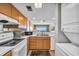 Functional kitchen design with wood cabinets, dishwasher and breakfast bar overlooks ocean view and living room at 5806 N Ocean Blvd. # 203, North Myrtle Beach, SC 29582