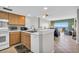 Cozy kitchen features wood cabinetry, stainless steel appliances, and a view to the living room and ocean beyond at 5806 N Ocean Blvd. # 203, North Myrtle Beach, SC 29582