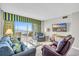 Bright living room featuring comfortable seating, a television, and an oceanfront balcony with seating at 5806 N Ocean Blvd. # 203, North Myrtle Beach, SC 29582