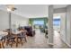 Open-concept living room with tile floors, a dining area, and ocean views through bright windows at 5806 N Ocean Blvd. # 203, North Myrtle Beach, SC 29582