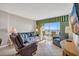 Comfortable living room with tile floors, ocean view balcony and cozy seating with a large TV at 5806 N Ocean Blvd. # 203, North Myrtle Beach, SC 29582