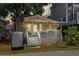 Charming yellow cottage with a welcoming front porch, string lights, and a cozy beach vibe at 6001 - 1820A S Kings Hwy., Myrtle Beach, SC 29575