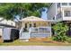 Charming yellow cottage with a welcoming front porch, string lights, and a cozy beach vibe at 6001 - 1820A S Kings Hwy., Myrtle Beach, SC 29575