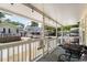 Inviting covered porch with string lights, a metal table and seating, perfect for relaxing at 6001 - 1820A S Kings Hwy., Myrtle Beach, SC 29575