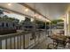Inviting covered porch with string lights, a metal table and seating, perfect for relaxing at 6001 - 1820A S Kings Hwy., Myrtle Beach, SC 29575