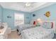 Charming bedroom features two twin beds, light blue walls, and ocean-themed decor at 601 Hillside Dr. N # 302, North Myrtle Beach, SC 29582