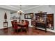 Inviting dining room featuring a wooden table set for six, elegant lighting, and a decorative cabinet at 601 Hillside Dr. N # 302, North Myrtle Beach, SC 29582