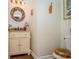 Unique half bathroom showcases a vanity with a round mirror and decorative toilet seat at 601 Hillside Dr. N # 302, North Myrtle Beach, SC 29582