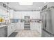 Bright kitchen featuring white cabinetry, stainless steel appliances, and ample counter space for meal preparation at 601 Hillside Dr. N # 302, North Myrtle Beach, SC 29582