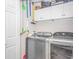 Functional laundry room with modern washer and dryer, storage cabinets, and ample space for laundry tasks at 601 Hillside Dr. N # 302, North Myrtle Beach, SC 29582