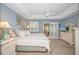 Serene main bedroom features a tray ceiling, ceiling fan and access to an outdoor living area at 601 Hillside Dr. N # 302, North Myrtle Beach, SC 29582