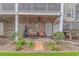 Charming covered patio with brick columns, beautiful landscaping, and comfortable seating at 601 Hillside Dr. N # 302, North Myrtle Beach, SC 29582