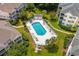 Aerial view of a community pool with lounge chairs and lush landscaping at 601 Hillside Dr. N # 302, North Myrtle Beach, SC 29582