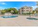 Community pool and hot tub with chairs and umbrella shaded tables for relaxing at 601 Hillside Dr. N # 302, North Myrtle Beach, SC 29582