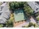 Aerial view of community tennis courts, surrounded by mature trees at 601 Hillside Dr. N # 302, North Myrtle Beach, SC 29582