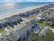 Aerial view of beachfront property with a pier in the distance near other homes at 612 N Ocean Blvd. # 103, Surfside Beach, SC 29575