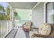 Cozy screened balcony with outdoor seating, perfect for relaxing and enjoying the coastal breeze at 612 N Ocean Blvd. # 103, Surfside Beach, SC 29575