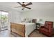 Charming bedroom with a cozy bed, side tables, a reading chair, and a sliding glass door to a private balcony at 612 N Ocean Blvd. # 103, Surfside Beach, SC 29575