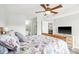 Bright bedroom featuring a bed with a patterned comforter, a TV, and an ensuite bathroom for added convenience at 612 N Ocean Blvd. # 103, Surfside Beach, SC 29575