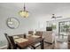 Cozy dining area features a wooden table set with seating for four, accented by a unique chandelier and beach-themed decor at 612 N Ocean Blvd. # 103, Surfside Beach, SC 29575