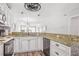 Kitchen featuring granite countertops, white cabinets, and modern appliances at 612 N Ocean Blvd. # 103, Surfside Beach, SC 29575