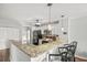 Stylish kitchen with breakfast bar, granite counters, and stainless steel appliances at 612 N Ocean Blvd. # 103, Surfside Beach, SC 29575