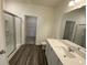 Modern bathroom featuring a glass-enclosed shower, vanity, and vinyl flooring at 620 Muster Field Ct., Conway, SC 29526