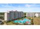 An aerial view of an oceanfront condo with a large lagoon style community pool at 6253 Catalina Dr. # 433, North Myrtle Beach, SC 29582