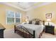 Comfortable bedroom featuring a tray ceiling, window with natural light, and stylish furnishings at 6253 Catalina Dr. # 433, North Myrtle Beach, SC 29582