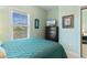 Cozy bedroom with a blue quilt, dresser with a TV, and light green walls at 6253 Catalina Dr. # 433, North Myrtle Beach, SC 29582