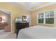 Comfortable bedroom includes a dresser with a television and a glimpse into the open-concept living room at 6253 Catalina Dr. # 433, North Myrtle Beach, SC 29582