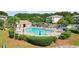 Community pool with lounge chairs, umbrellas, and a grassy area at 6253 Catalina Dr. # 433, North Myrtle Beach, SC 29582
