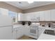 Bright kitchen with white appliances and a window view at 6253 Catalina Dr. # 433, North Myrtle Beach, SC 29582