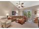 Cozy living room boasts comfortable seating, a ceiling fan, and access to an outdoor balcony with natural light at 6253 Catalina Dr. # 433, North Myrtle Beach, SC 29582