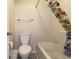 Clean bathroom featuring a bathtub with a shower, a toilet, and neutral décor at 637 Waterway Village Blvd. # 13C, Myrtle Beach, SC 29579