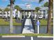 Charming community bridge over water, adorned with palm trees, enhancing the serene and picturesque atmosphere at 637 Waterway Village Blvd. # 13C, Myrtle Beach, SC 29579