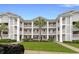 Charming condo building with private balconies and lush landscaping under a clear blue sky at 637 Waterway Village Blvd. # 13C, Myrtle Beach, SC 29579
