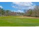 Lush golf course with manicured greens, mature trees, and blue skies, offering a serene outdoor experience at 637 Waterway Village Blvd. # 13C, Myrtle Beach, SC 29579