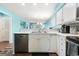 Well-lit kitchen with white cabinetry, stainless steel appliances, and an open view into the living room at 637 Waterway Village Blvd. # 13C, Myrtle Beach, SC 29579