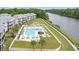 Aerial view of a community pool with lounge chairs, hot tub, and manicured landscaping at 637 Waterway Village Blvd. # 13C, Myrtle Beach, SC 29579