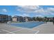 Well-maintained tennis court with vibrant blue surface, surrounded by lush landscaping and community buildings at 637 Waterway Village Blvd. # 13C, Myrtle Beach, SC 29579