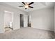 Comfortable bedroom featuring a ceiling fan, plush carpeting, and an adjoining bathroom and closet at 647 Snowy Owl Way, Conway, SC 29527
