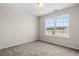 Cozy bedroom featuring neutral carpeting, a bright window view, and ample space for furnishings at 647 Snowy Owl Way, Conway, SC 29527