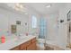 Well-lit bathroom featuring a vanity, mirror, toilet, and a shower with a patterned curtain at 6478 Royal Pine Dr., Myrtle Beach, SC 29588