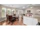 A dining area off of the kitchen leads to a living room with large windows at 6478 Royal Pine Dr., Myrtle Beach, SC 29588