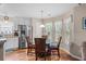Cozy breakfast nook features a modern table, natural light, and stainless steel appliances at 6478 Royal Pine Dr., Myrtle Beach, SC 29588