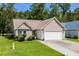 Beautiful one-story home with attached two-car garage, manicured lawn, and mature landscaping at 6478 Royal Pine Dr., Myrtle Beach, SC 29588